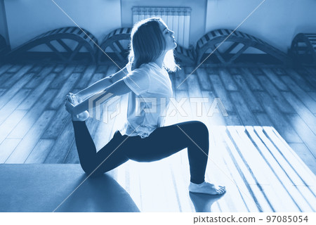 Portrait of a beautiful young woman in yoga pose 97085054