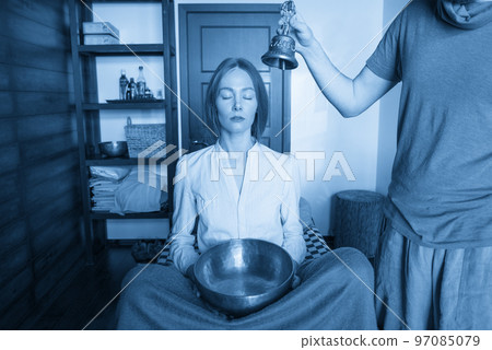 Tibetan singing bowls and bell in sound therapy in spa center 97085079