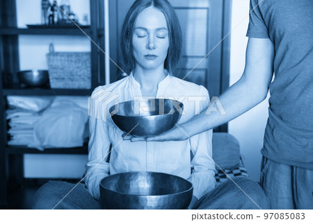 Tibetan singing bowls in sound therapy in spa center 97085083