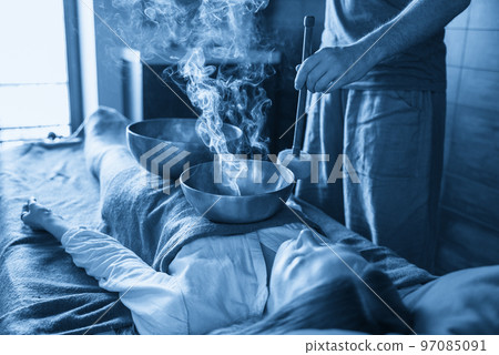 Tibetan singing bowls in sound therapy in spa center 97085091