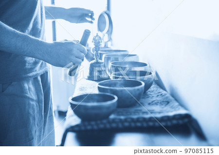Tibetan singing bowls in sound therapy in spa center 97085115