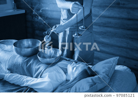 Tibetan singing bowls in sound therapy in spa center 97085121