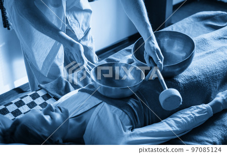 Tibetan singing bowls in sound therapy in spa center 97085124