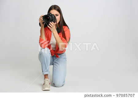 Professional photographer working on white background in studio Professional photographer working on white background in studio 97085707