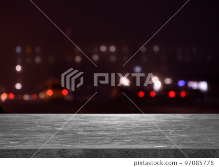 Empty grey stone surface against blurred view of night city. Bokeh effect Empty grey stone surface against blurred view of night city. Bokeh effect 97085778