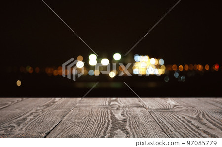 Empty wooden surface against blurred lights. Bokeh effect Empty wooden surface against blurred lights. Bokeh effect 97085779