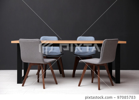 Modern empty wooden table near black wall Modern empty wooden table near black wall 97085783