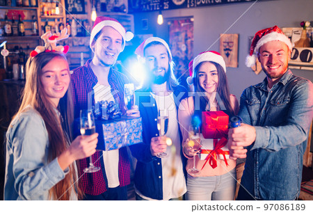 Friends celebrating new year's together. Portrait of Friends With Drinks Enjoying Cocktail Party. Friends celebrating new year's together. Portrait of Friends With Drinks Enjoying Cocktail Party. 97086189