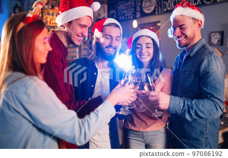 Friends celebrating new year's together. Portrait of Friends With Drinks Enjoying Cocktail Party. Friends celebrating new year's together. Portrait of Friends With Drinks Enjoying Cocktail Party. 97086192