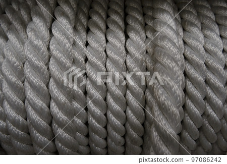 Bobbin of synthetic rough cord closeup texture background 97086242