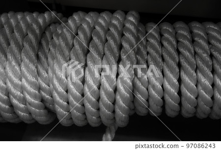 Bobbin of white synthetic wire rope isolated on black background 97086243
