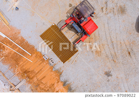 Forklift delivery on construction site reinforce concrete steel rods bars to foundation Forklift delivery on construction site reinforce concrete steel rods bars to foundation 97089022