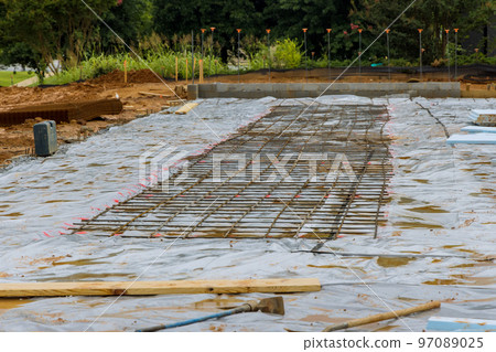 Construction site an installation reinforcement steel bars to concrete foundations during construction process Construction site an installation reinforcement steel bars to concrete foundations during construction process 97089025