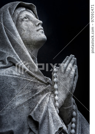 Faithfull Virgin Mary with praying hands and blessing, looking at the sky Faithfull Virgin Mary with praying hands and blessing, looking at the sky 97091471