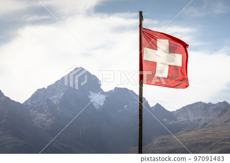 Swiss flag and Bernina mountain range with glaciers in the Alps, Switzerland 97091483