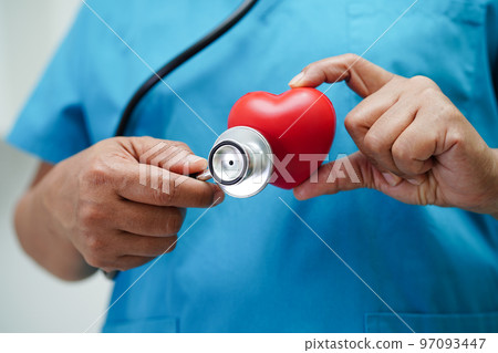 Asian woman doctor holding red heart for health in hospital. 97093447