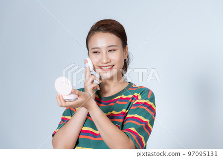 beautiful young woman using beauty blender for applying foundation for make-up on face isolated beautiful young woman using beauty blender for applying foundation for make-up on face isolated 97095131