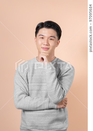 Happy smiling young handsome Asian man face with hand touching chin Happy smiling young handsome Asian man face with hand touching chin 97095684