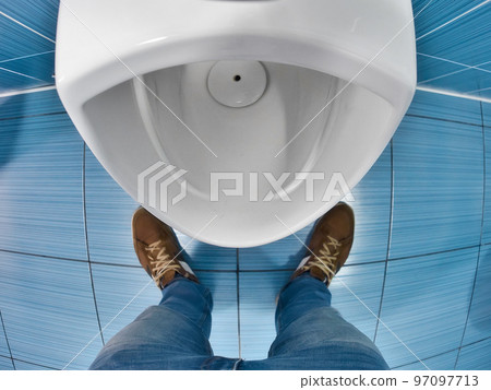 Man stands in front of toilet in toilet and tries to urinate. First-person view. Urinary problem and 97097713