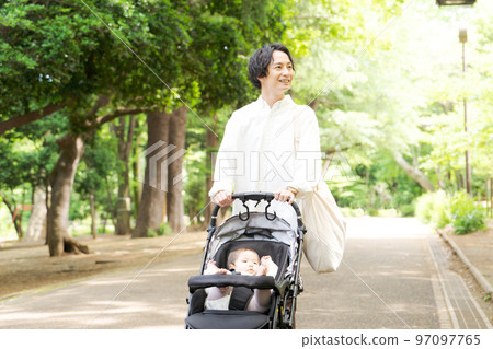 dad and baby playing in the park 97097765