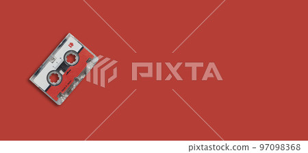Mini cassette tape on colored background. 97098368
