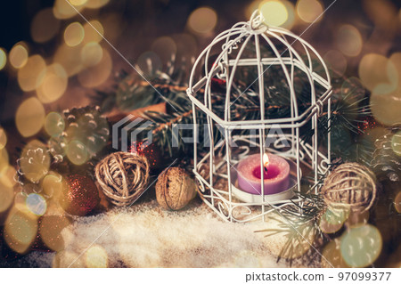 Christmas card.vintage Christmas candle on festive background. beautiful bokeh effect from a garland. Christmas card.vintage Christmas candle on festive background. beautiful bokeh effect from a garland. 97099377
