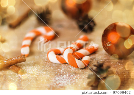 background image cookies,Christmas balls and cones on wooden background. beautiful bokeh effect from a garland. background image cookies,Christmas balls and cones on wooden background. beautiful bokeh effect from a garland. 97099402
