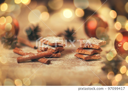Christmas table. blurred image homemade cookies on wooden background. beautiful bokeh effect from a garland. 97099417