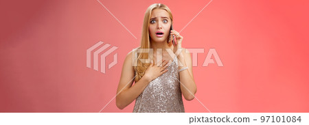 Concerned worried woman blond hairstyle in silver stylish glittering dress hold hand heart widen eyes afraid gasping speechless listen terrifying news talking smartphone express empathy worry Concerned worried woman blond hairstyle in silver stylish glittering dress hold hand heart widen eyes afraid gasping speechless listen terrifying news talking smartphone express empathy worry 97101084