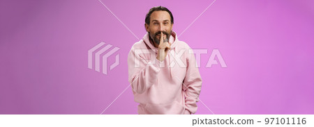 Lips sealed secret. Portrait alluring cheeky stylish adult bearded guy in pink hoodie asking keep quiet show shush shh gesture index finger pressed mouth smiling devious smug face, have idea 97101116