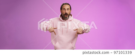 Impressed fascinated speechless dad bearded grey hair say wow widen eyes surprised folding lips amused curiously pointing down index fingers see super amazing advertisement, posing purple background Impressed fascinated speechless dad bearded grey hair say wow widen eyes surprised folding lips amused curiously pointing down index fingers see super amazing advertisement, posing purple background 97101339