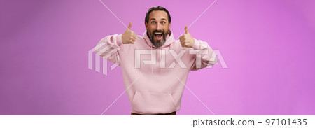 Excited energized supportive charismatic european mature bearded man in pink hoodie show thumbs up gesture smiling agree approving recommending awesome product, standing purple background satisfied Excited energized supportive charismatic european mature bearded man in pink hoodie show thumbs up gesture smiling agree approving recommending awesome product, standing purple background satisfied 97101435