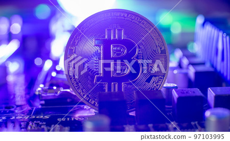 Cryptocurrency concept , Golden bitcoin on winners cup background mainboard , The future of money. Computational equipment. 97103995