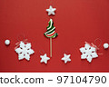 Christmas or winter composition. Frame made of snowflakes and candy trees on a red background. Christmas, winter, new year concept. Flat lay 97104790