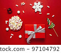 Christmas or winter composition. Cup with coffee, marshmallows, gift and Christmas decor. Flat lay, top view 97104792