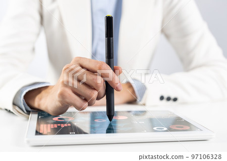 Man in business suit using tablet computer 97106328