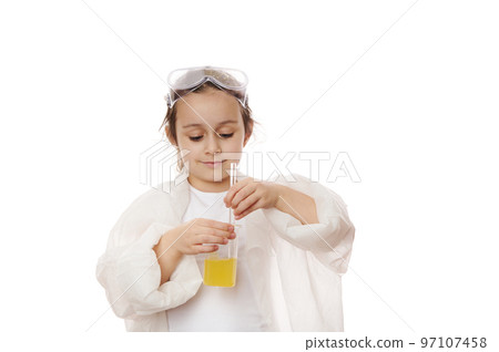 Smart child, lovely little girl, young chemist scientist in lab coat, using laboratory stick, mixing yellow liquid chemical with reagents in a beaker, isolated on white background. Chemistry lesson 97107458
