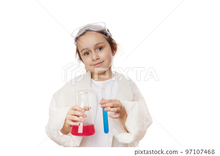 Happy smart little girl, primary school student, future chemist scientist in lab coat, holding test tube and lab flask, doing chemistry experiment, on white background. Profession and science concept Happy smart little girl, primary school student, future chemist scientist in lab coat, holding test tube and lab flask, doing chemistry experiment, on white background. Profession and science concept 97107468