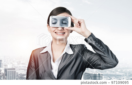 Woman covering her eyes with smartphone Woman covering her eyes with smartphone 97109095