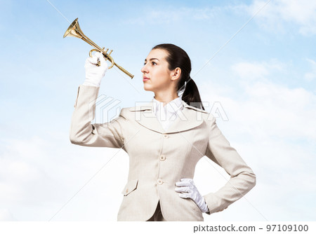 Beautiful woman playing trumpet brass Beautiful woman playing trumpet brass 97109100