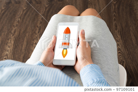 Businesswoman with a smartphone and her startup Businesswoman with a smartphone and her startup 97109101