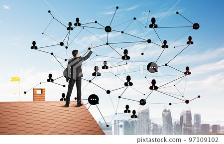Businessman on house roof presenting networking and connection concept. Mixed media Businessman on house roof presenting networking and connection concept. Mixed media 97109102