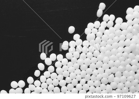 Close up picture of polyamide granules on a dark background, selective focus. 97109627