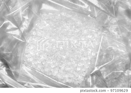 Close up picture of polypropylene granules in a plastic bag, selective focus. 97109629