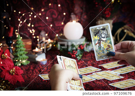 Tarot reader or Fortune teller reading on Christmas decoration. 97109676