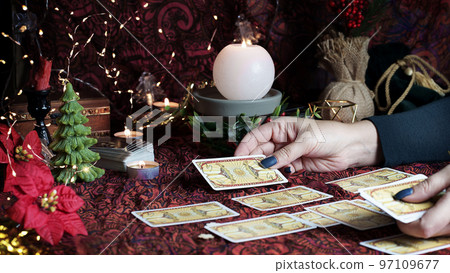 Tarot reader or Fortune teller reading on Christmas decoration. Tarot reader or Fortune teller reading on Christmas decoration. 97109677