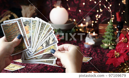 Tarot reader or Fortune teller reading on Christmas decoration. Tarot reader or Fortune teller reading on Christmas decoration. 97109679