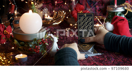 Tarot reader or Fortune teller reading on Christmas decoration. Tarot reader or Fortune teller reading on Christmas decoration. 97109680