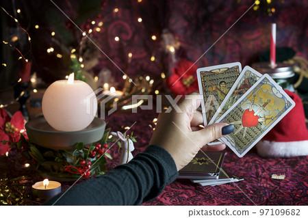 Tarot reader or Fortune teller reading on Christmas decoration. Tarot reader or Fortune teller reading on Christmas decoration. 97109682
