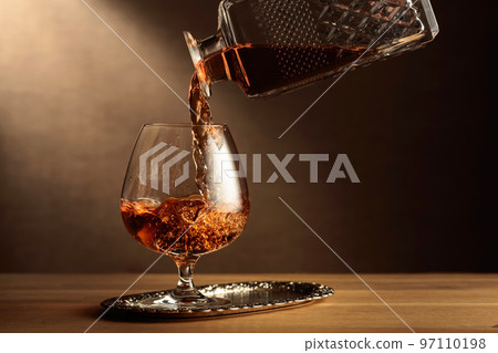 Brandy is poured into a snifter glass. 97110198